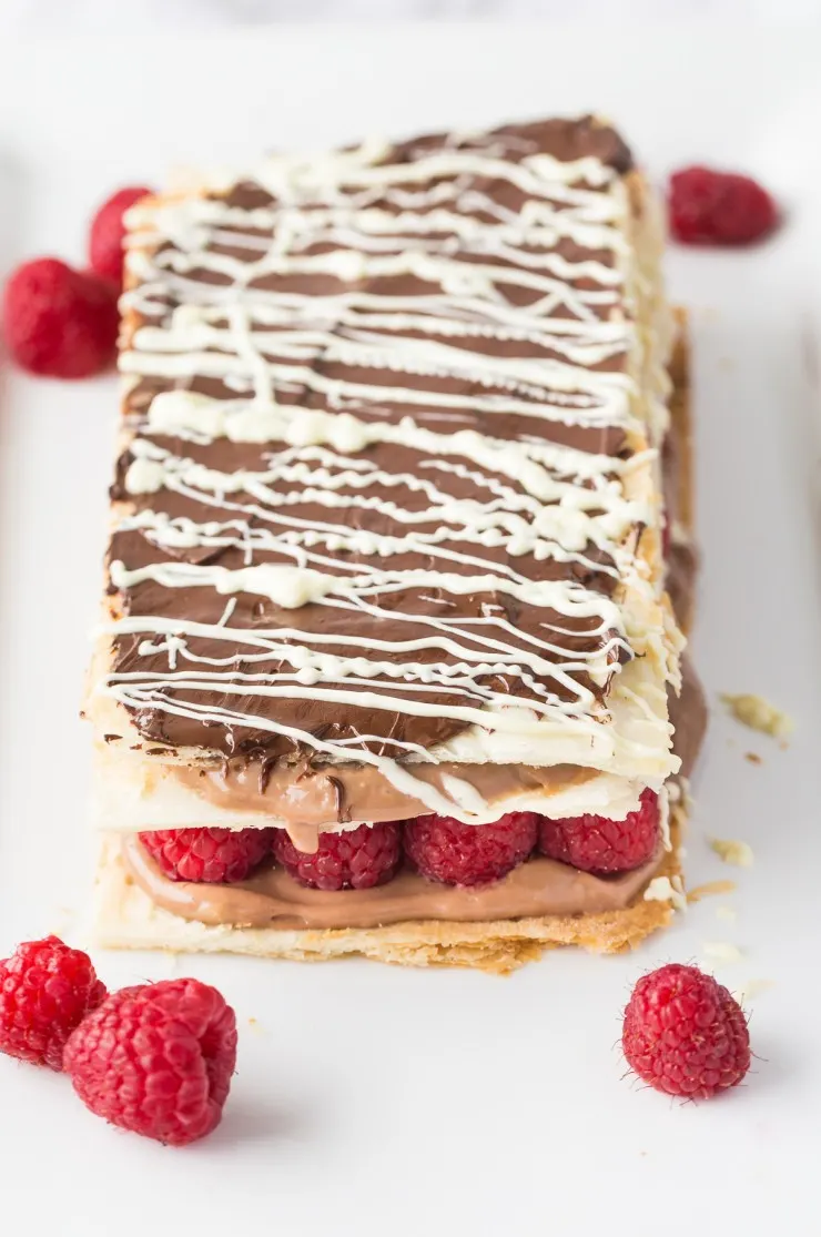 Make a decadent bakery shop treat at home with this indulgent recipe for a Chocolate and Raspberry Napoleon. Fresh raspberries stud chocolate pastry cream layered between airy sheets of puff pastry in this chocolate-raspberry dessert. A match made in heaven! 