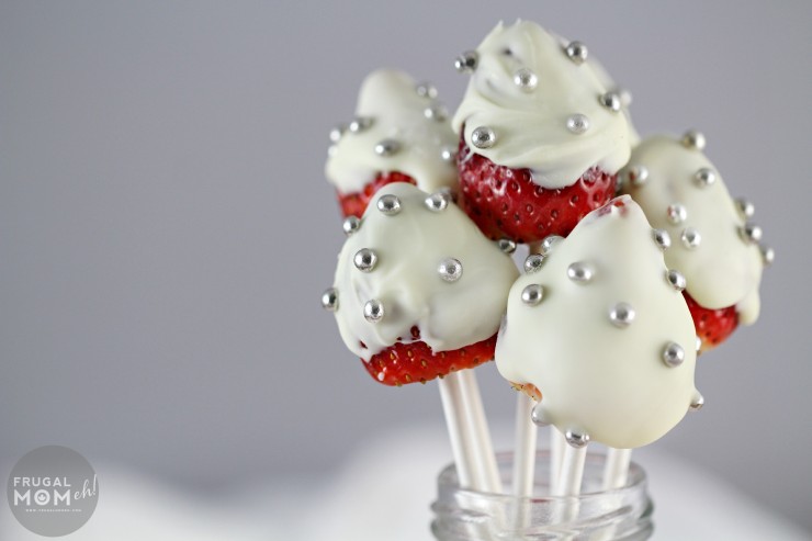 White Chocolate Covered Strawberry Pops dotted with silver nonpareils are perfect for a Valentine's Day or Date Night Dessert.  They also look great as part of a Valentines Day tablescape! 