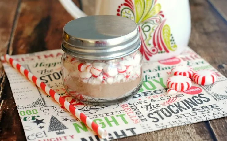 Peppermint Cocoa Mini Gift Jars. Cute, frugal gift idea! Mason jar filled with homemade hot cocoa powder topped with peppermint for a great giftable treat!