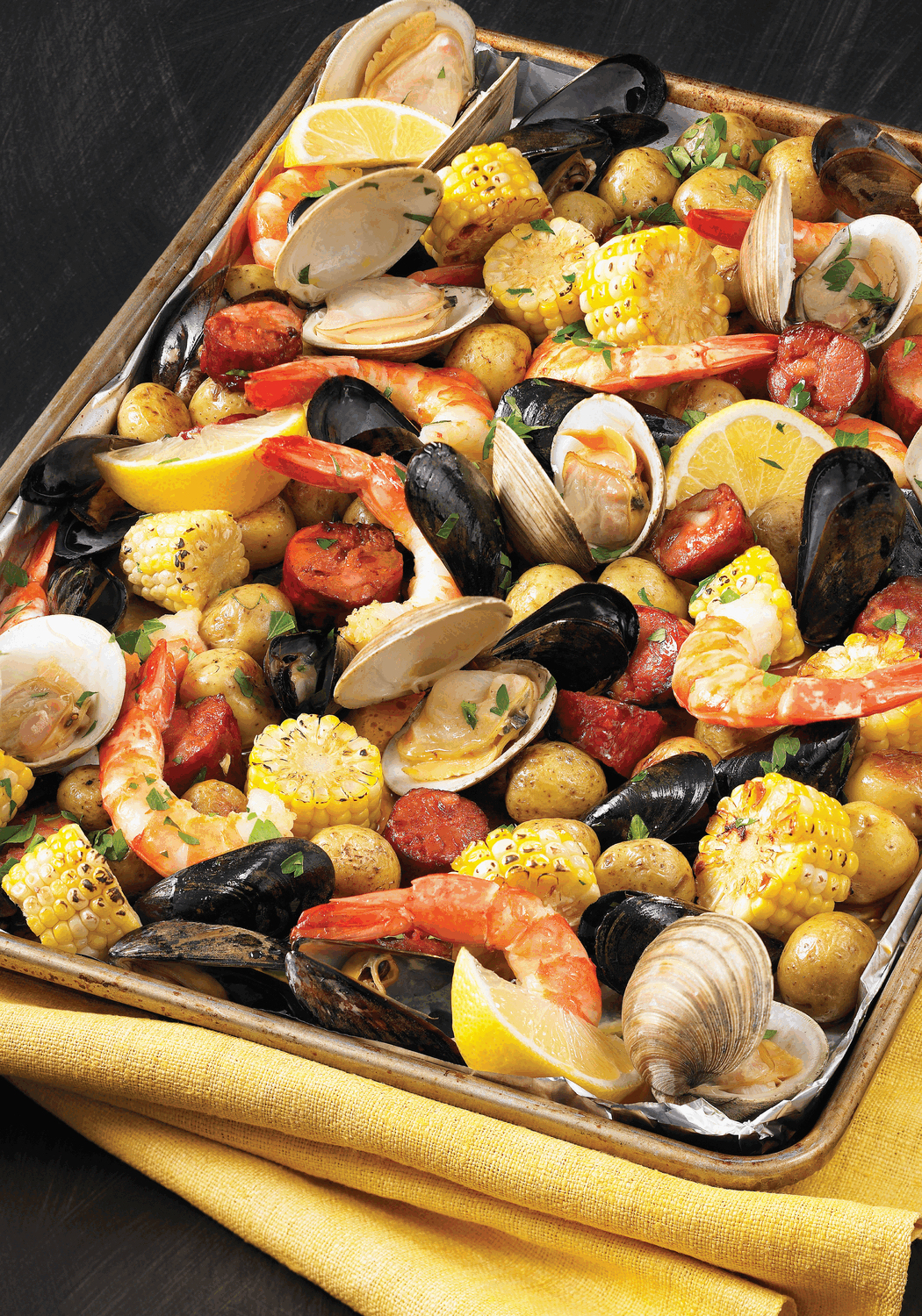 No need to head to the beach: this sheet pan preparation delivers the New England flavors of a classic clam bake to your kitchen anytime.