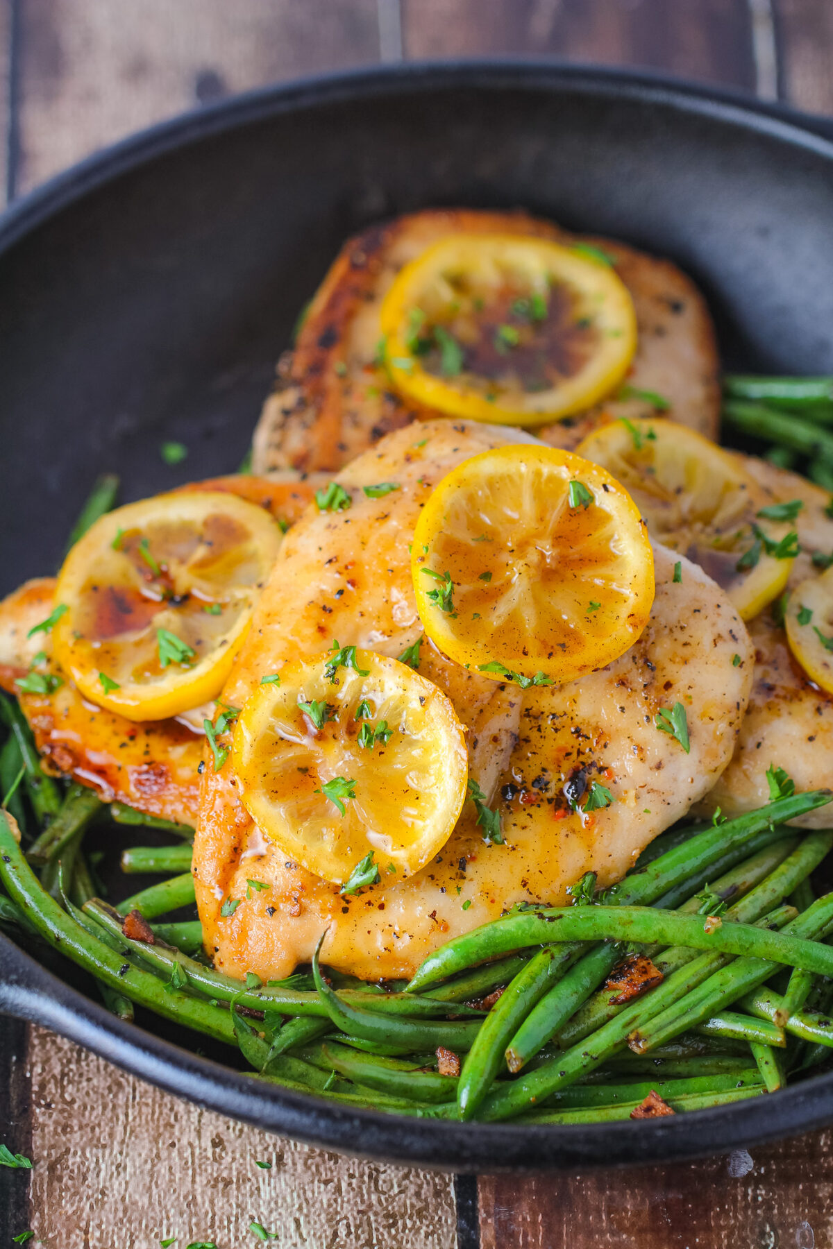 Easy lemon pepper chicken made in one pan with fresh lemon, honey, butter, and herbs. Juicy pan-fried chicken breasts ready in 30 minutes.