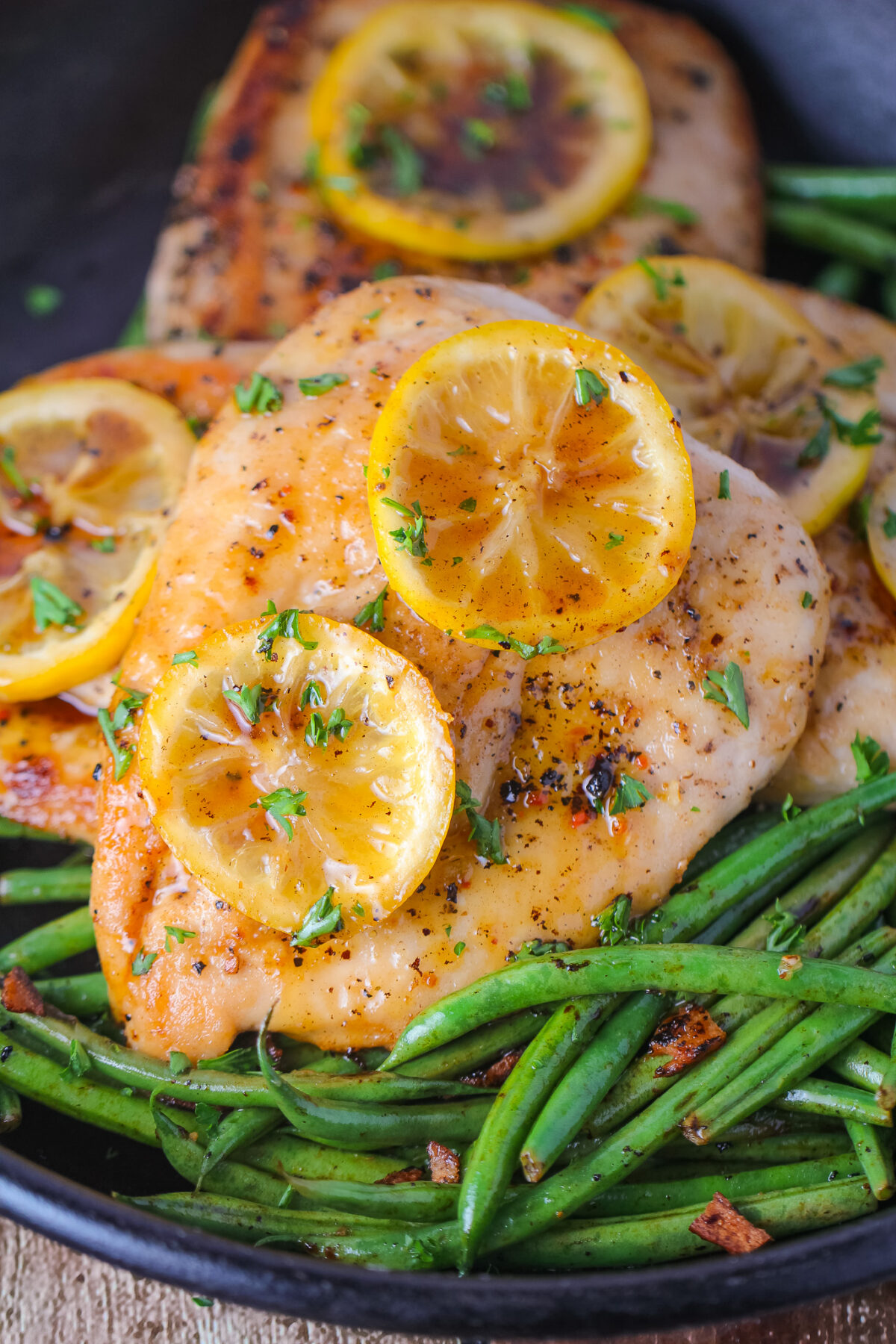 Easy lemon pepper chicken made in one pan with fresh lemon, honey, butter, and herbs. Juicy pan-fried chicken breasts ready in 30 minutes.