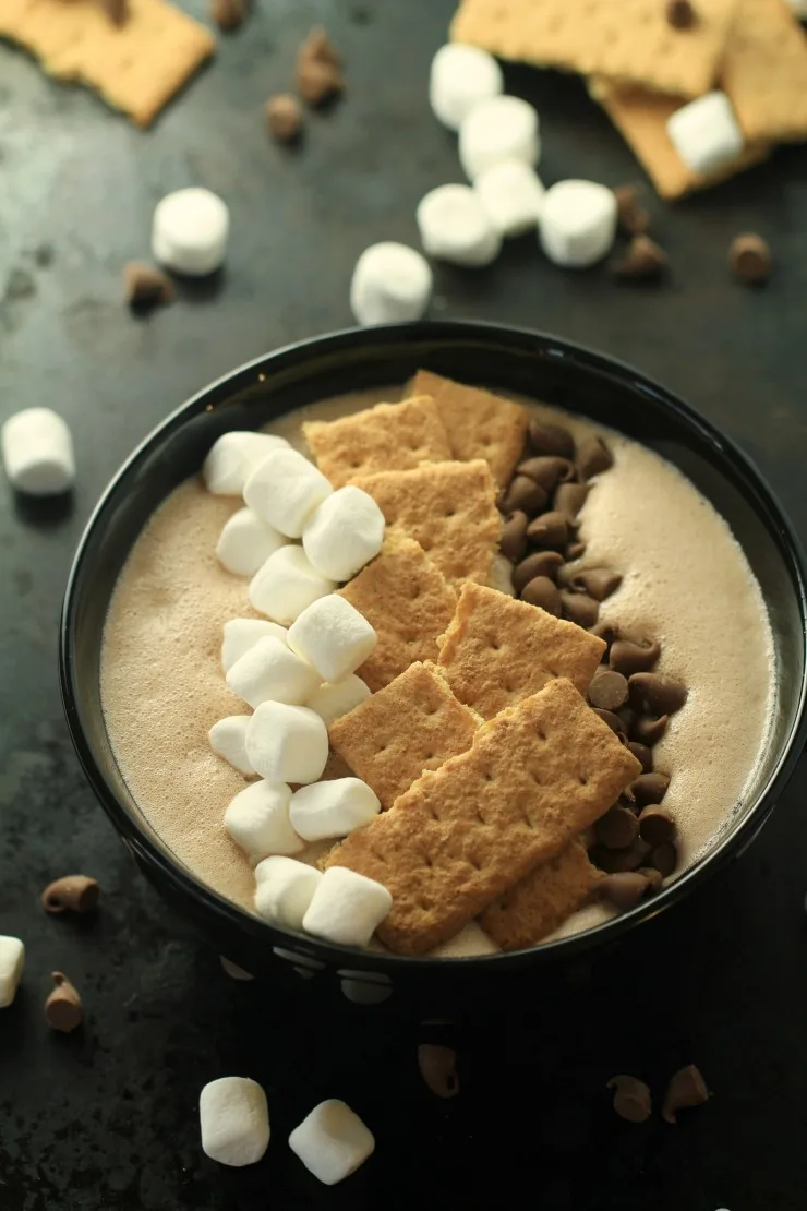 This S'mores Smoothie Bowl is a fun way for everyone to enjoy the taste of a summer camping recipe classic at home.  Your family is going to love this quick and easy dessert recipe!