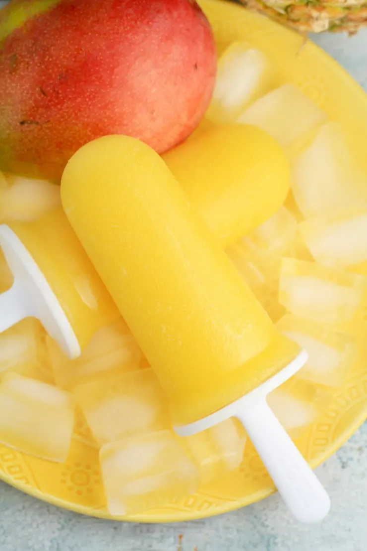 These super delicious and healthy Mango & Pineapple Ice Pops are made with only 3 ingredients! Your entire family will love these delicious tropical treats all summer long!