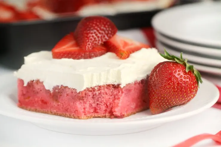 This strawberry poke cake is a delicious twist on that classic summer treat - strawberry shortcake. Fresh strawberries make this the most delicious strawberry cake you've ever had!