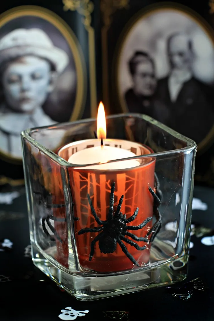 This Halloween Votive is a an easy and spooky Halloween Décor idea that can be made from items founds at the dollar store. Cast a spooky glow on all your Halloween activities with a votive covered in creepy crawlies!