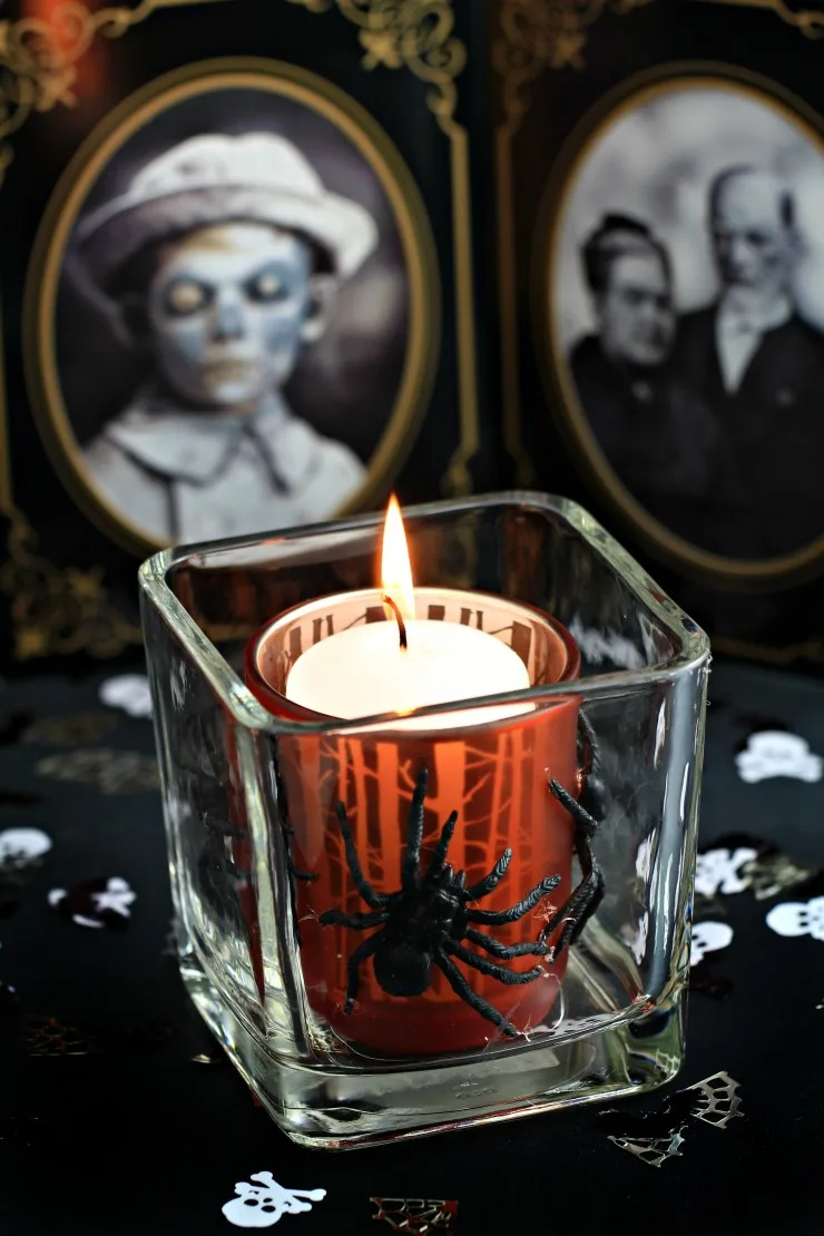 This Halloween Votive is a an easy and spooky Halloween Décor idea that can be made from items founds at the dollar store. Cast a spooky glow on all your Halloween activities with a votive covered in creepy crawlies!