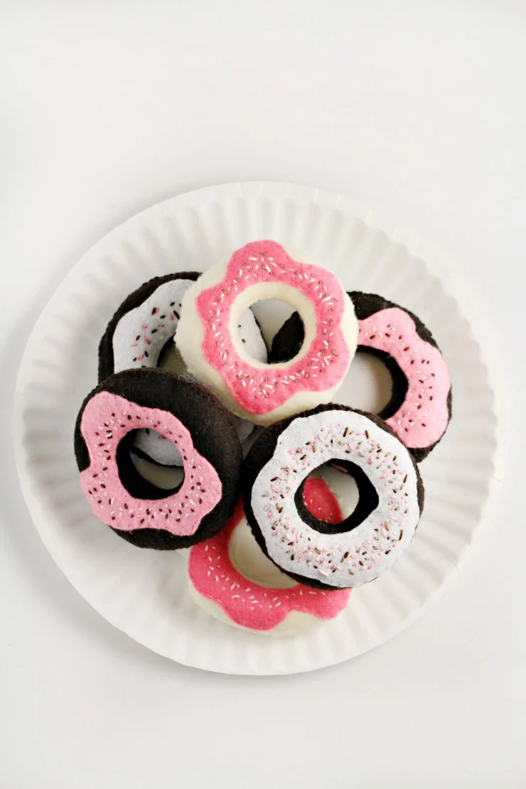 These Handmade Toy Donuts are easy to make and oh so sweet with a sprinkle of stitches. They are a great complement to a toy tea set or play kitchen.