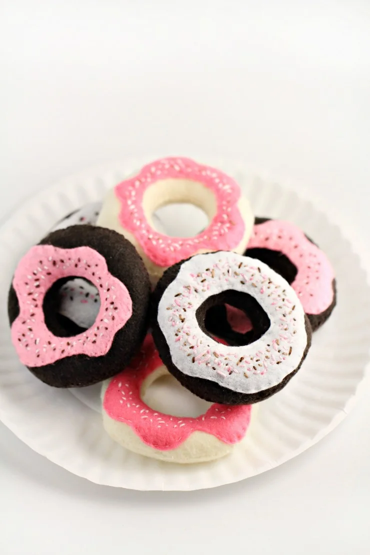 These Handmade Toy Donuts are easy to make and oh so sweet with a sprinkle of stitches. They are a great complement to a toy tea set or play kitchen.