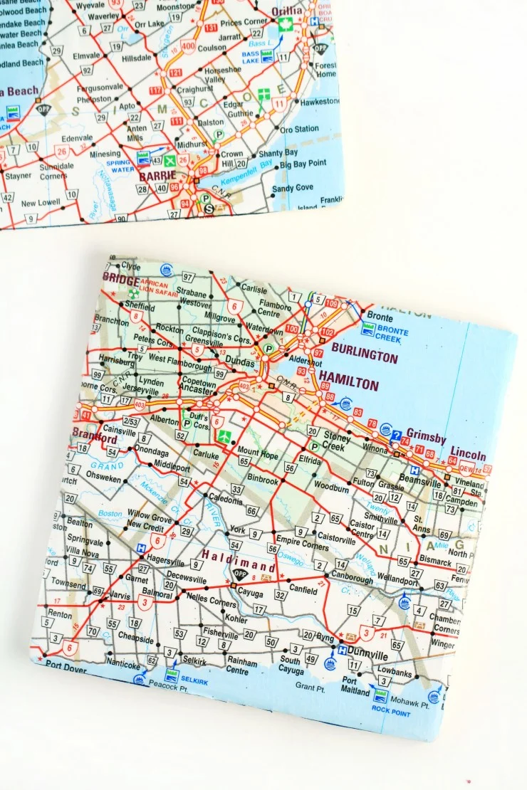 Upcycle old maps to create fun and pretty map coasters. Use local maps or maps from your travels to create these diy unique pieces.