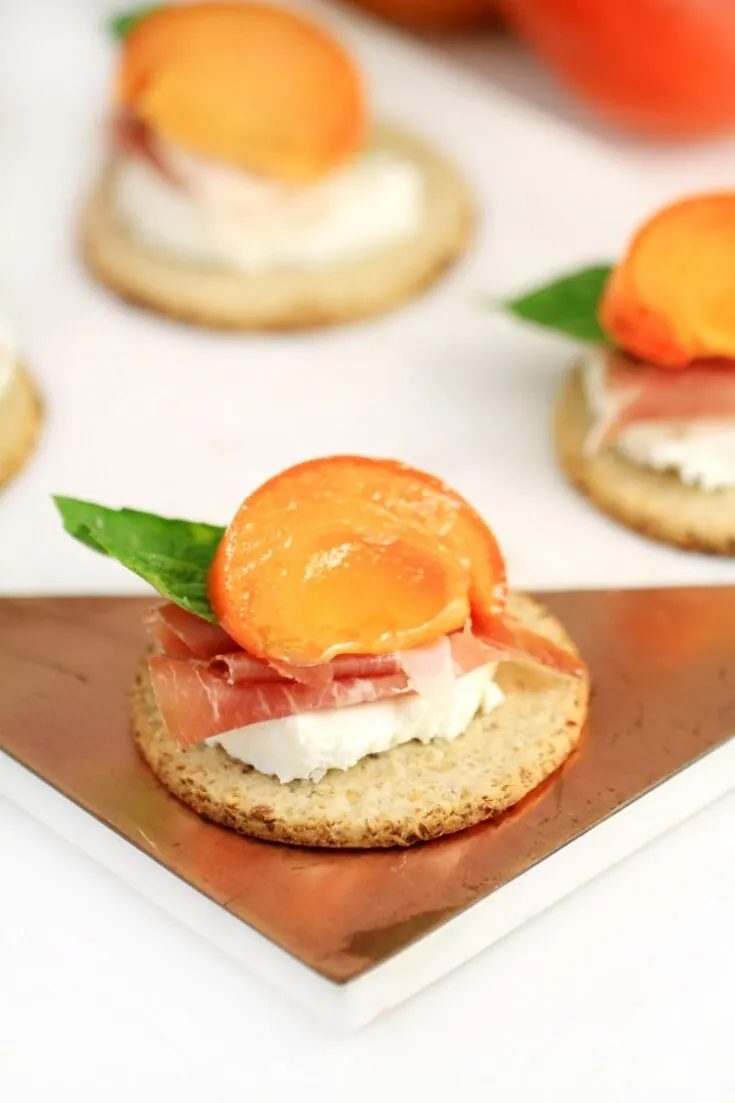 Marinated Persimmon with Prosciutto and Goat Cheese Topped Oatcakes