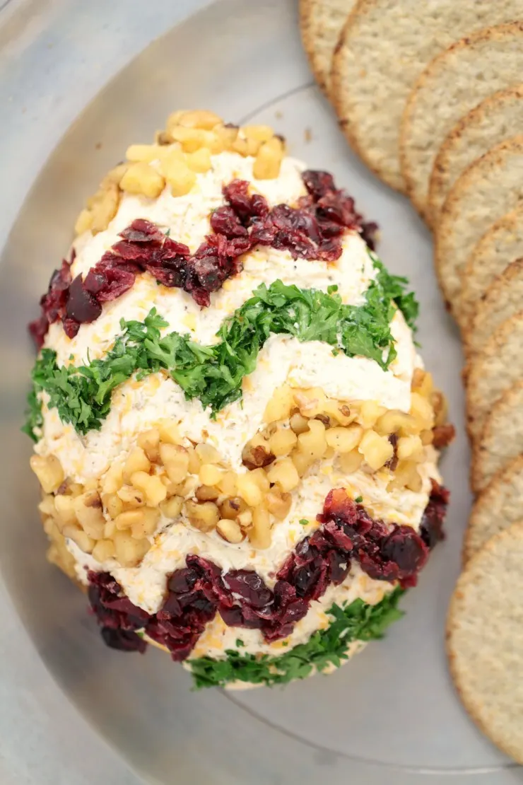 This Easter Egg Cheese Ball is an adorable Easter appetizer that is easy to make and super delicious. Start with a classic cheeseball and decorate for a unique Easter themed appetizer to serve at your Easter dinner party!