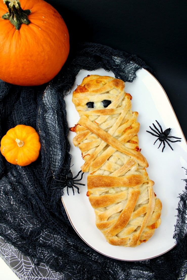 These Mummy Calzones are perfect Halloween party food - a delicious and not so spooky meal that kids and adults will enjoy alike.