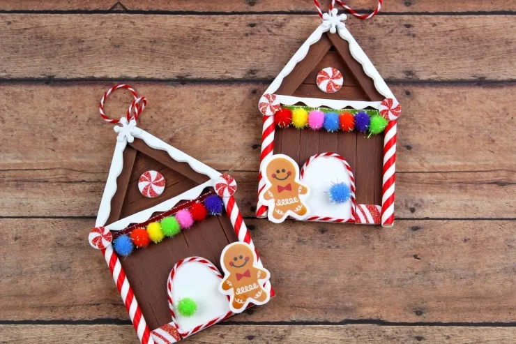 These Popsicle Stick Gingerbread House Christmas Ornaments are an adorable and festive holiday craft that make for great keepsake gifts that look great on a Christmas tree. We had so much fun making these Christmas ornaments!
