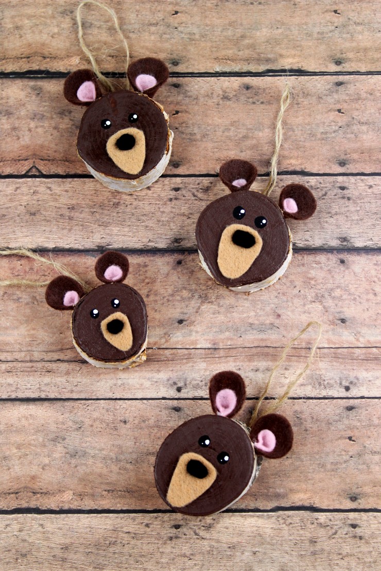  These Wood Slice Brown Bear Ornaments are an easy Christmas ornament craft that results in adorably rustic décor for your tree!