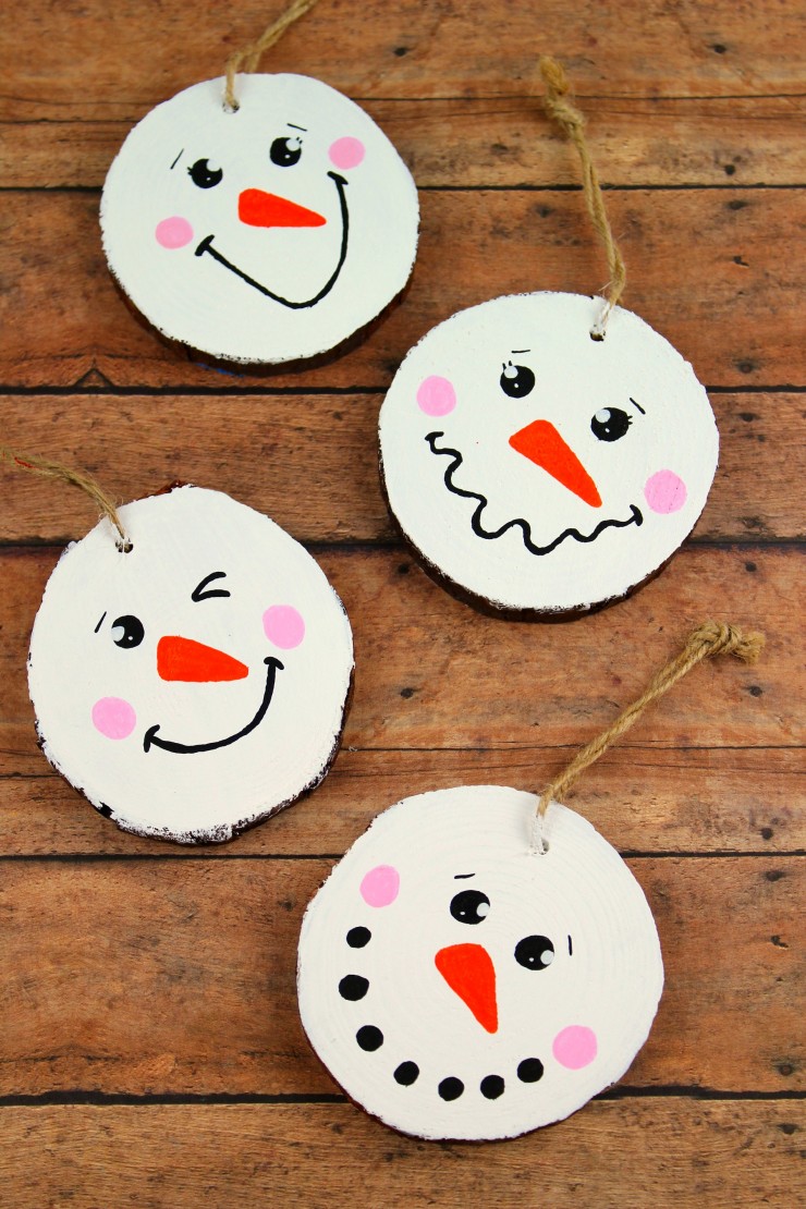 These Wood Slice Snowman Ornaments are an adorable and festive holiday craft that make for great gifts and look great on a Christmas tree.  We had so much fun making these Christmas ornaments!