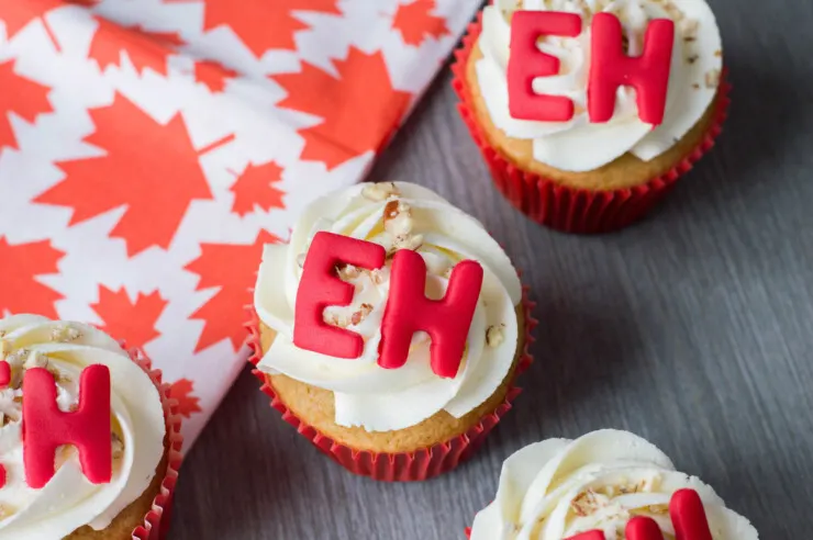 These Maple cupcakes adorned with fondant "Eh's" are the perfect Canada Day weekend treat. Celebrate with family and friends and these adorable Canada Day Cupcakes!