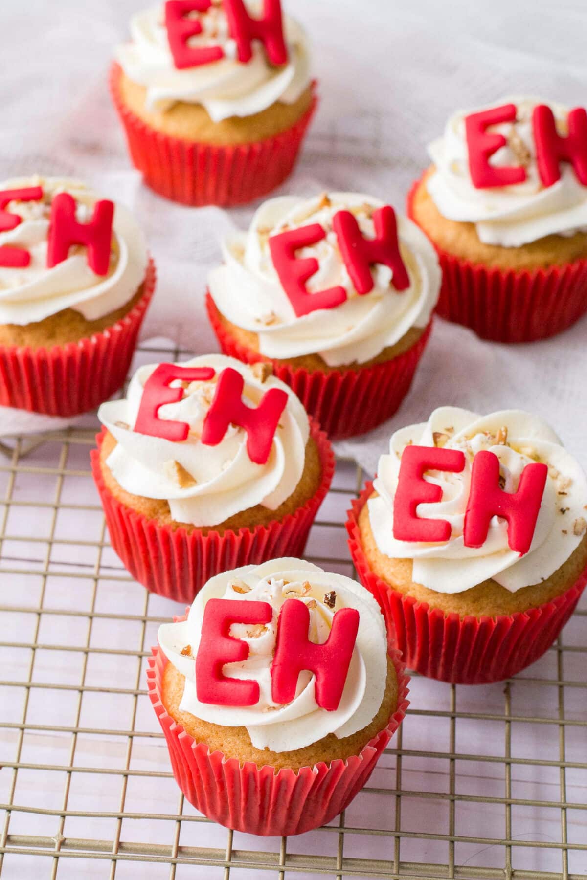 Soft maple cupcakes topped with maple buttercream, and fun "Eh" decorations. A festive dessert that's perfect for Canada Day celebrations.