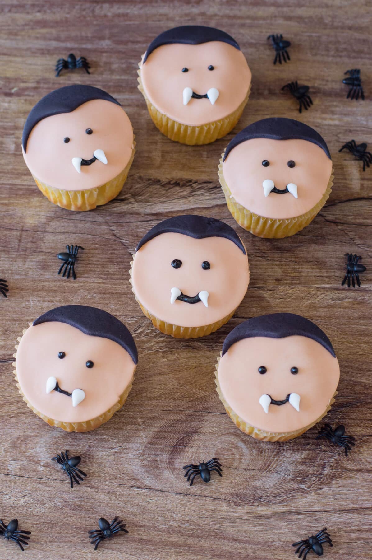 Make these adorable Vampire Cupcakes for Halloween! Easy cake mix cupcakes decorated with fondant vampire faces with little fangs.