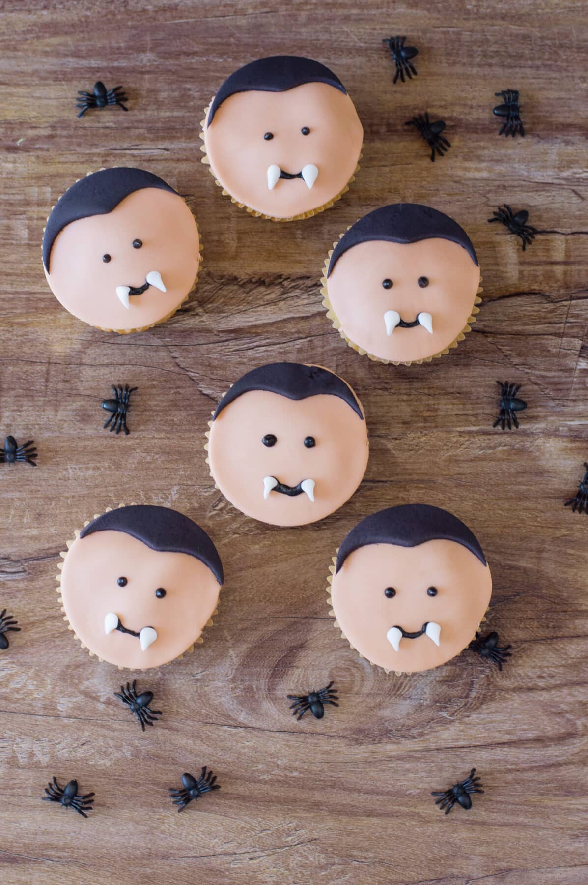 Make these adorable Vampire Cupcakes for Halloween! Easy cake mix cupcakes decorated with fondant vampire faces with little fangs.