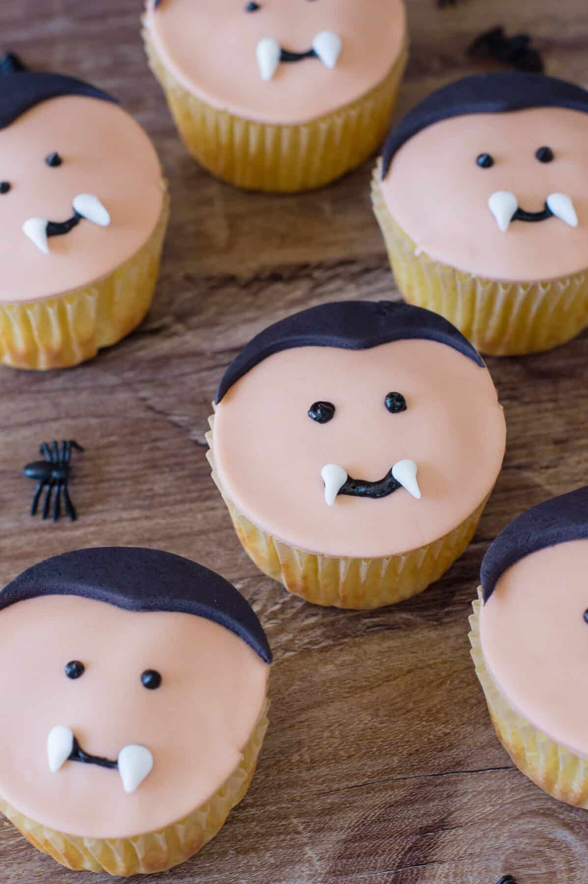 Make these adorable Vampire Cupcakes for Halloween! Easy cake mix cupcakes decorated with fondant vampire faces with little fangs.