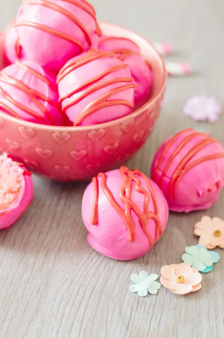 These Valentine's Day Cake Truffles are sure to impress everyone this Valentine’s Day! These little bites of creamy cake covered in chocolate are just so delicious. Valentine's Day Cake Balls are easy to make and perfectly festive.