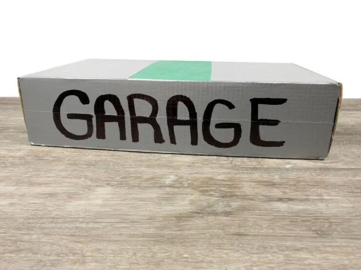 This Portable Garage with Mini Race Track is a fun DIY project to upcycle toilet paper rolls. It makes for a great handmade gift that kids will love and use for years, and the perfect way to store away all those small cars.