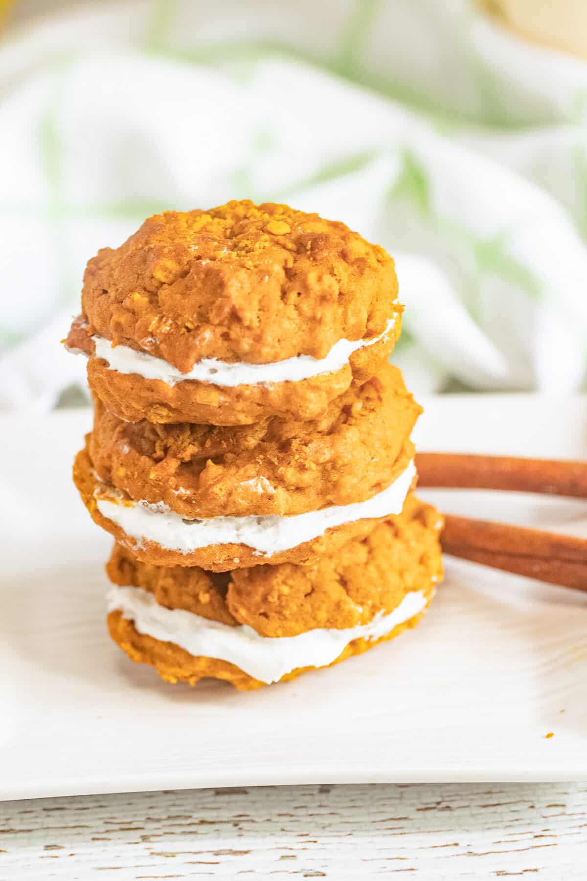 These Pumpkin Oatmeal Whoopie Pies feature soft, spiced pumpkin oatmeal cookies sandwiched with a fluffy marshmallow filling.