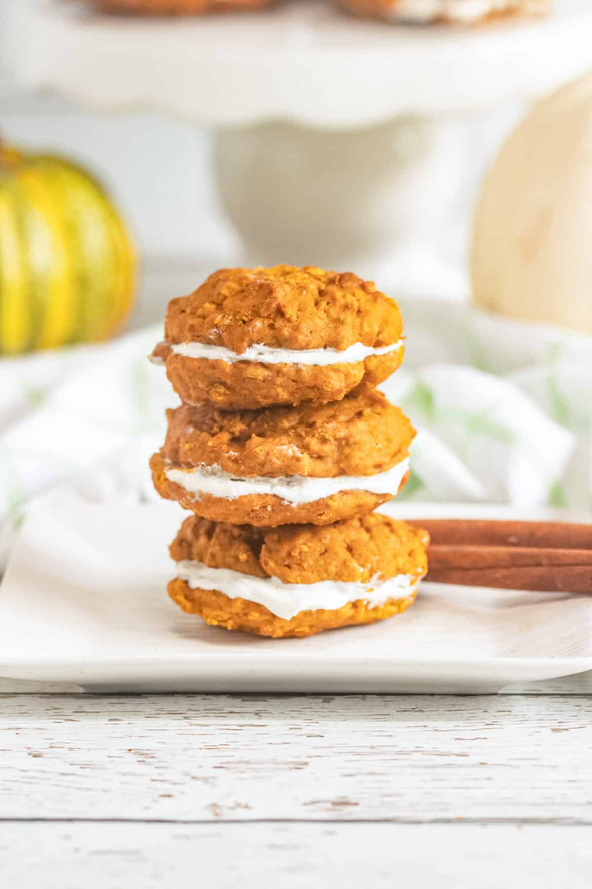 These Pumpkin Oatmeal Whoopie Pies feature soft, spiced pumpkin oatmeal cookies sandwiched with a fluffy marshmallow filling.