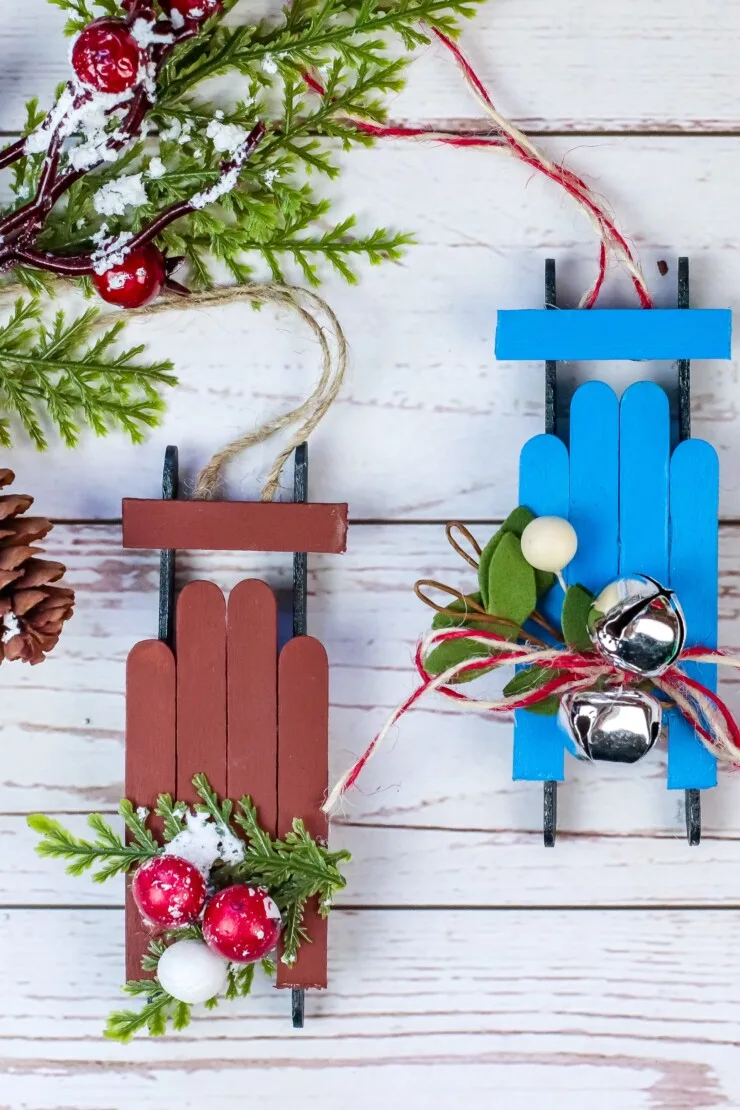  This Wooden Sled Ornament Craft is made with craft sticks and a few other basic supplies for an adorable Christmas tree ornament.