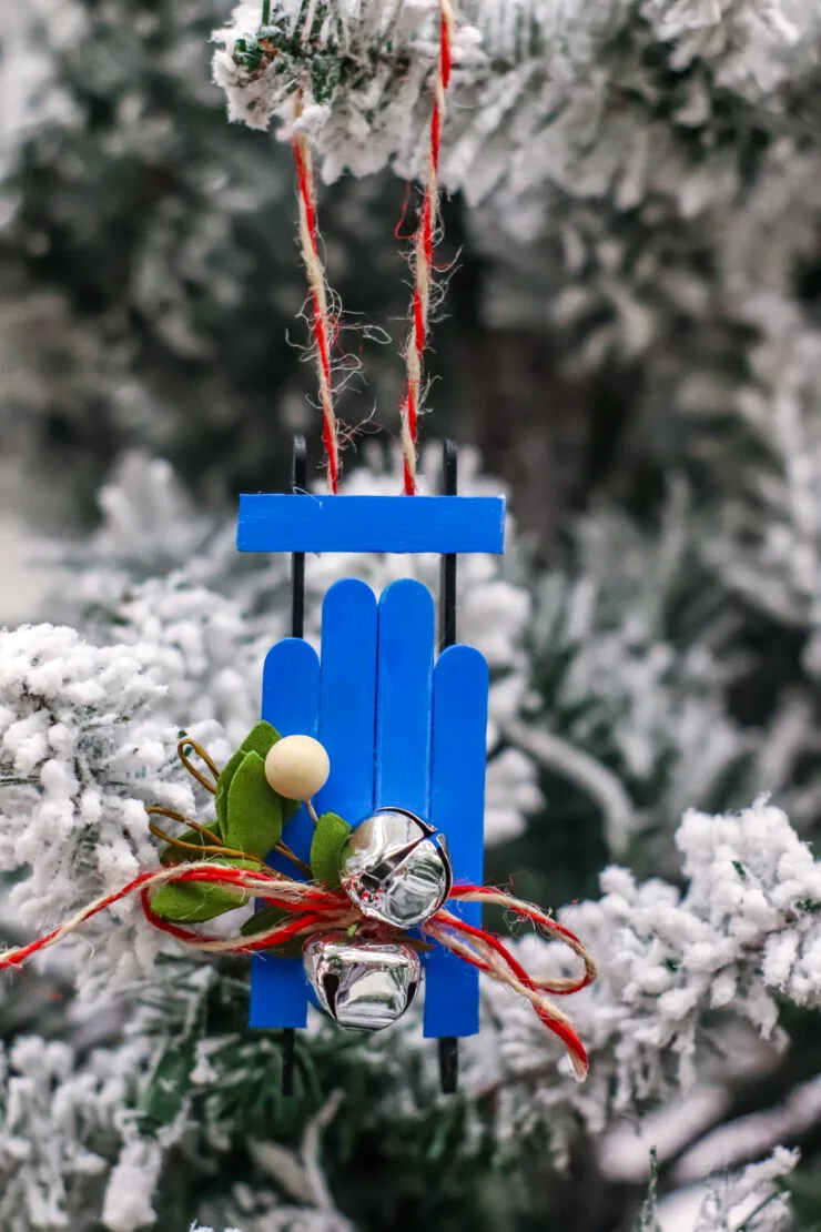  This Wooden Sled Ornament Craft is made with craft sticks and a few other basic supplies for an adorable Christmas tree ornament.