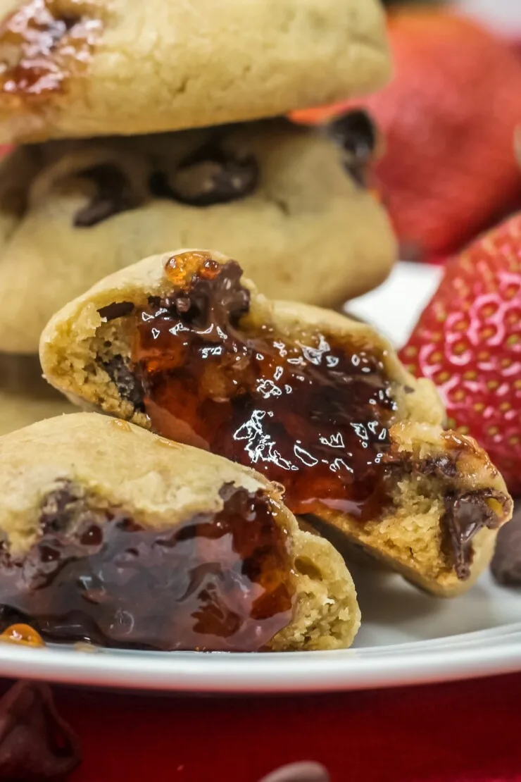 Classic chocolate chip cookies are filled with gooey strawberry jam in this Chocolate Covered Strawberry Cookies recipe. 