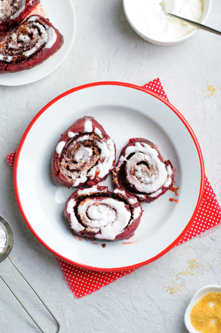 These red velvet cinnamon rolls are delicious, tender, oh so decadent. Turn a box of red velvet cake mix into this stunning dessert! Perfect for a Valentine's Day treat.