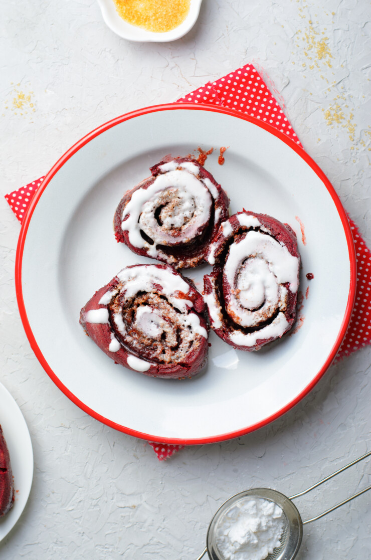 These red velvet cinnamon rolls are delicious, tender, oh so decadent. Turn a box of red velvet cake mix into this stunning dessert! Perfect for a Valentine's Day treat.