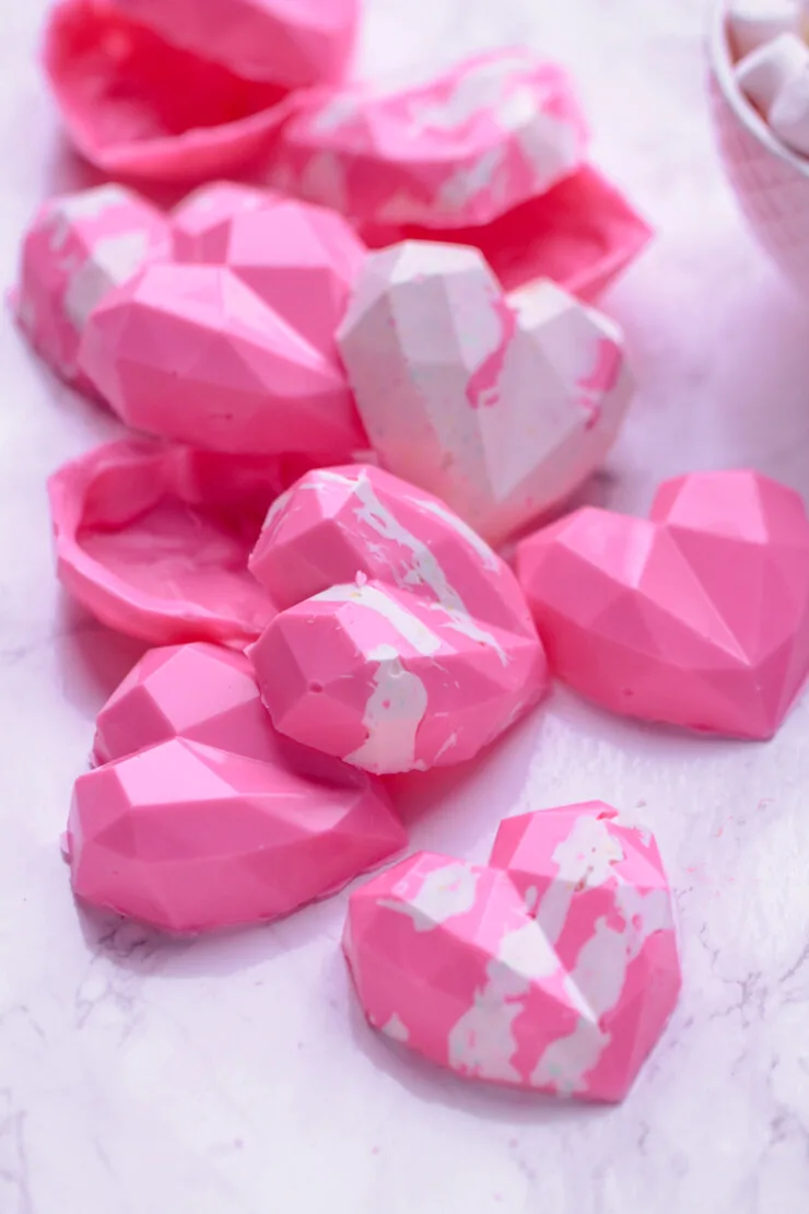 These geometric heart hot chocolate bombs are a fun and trendy Valentine's Day treat for kids, featuring pink hot cocoa with Marshmallows.