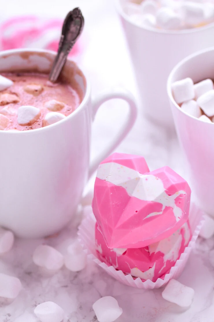 These geometric heart hot chocolate bombs are a fun and trendy Valentine's Day treat for kids, featuring pink hot cocoa with Marshmallows.