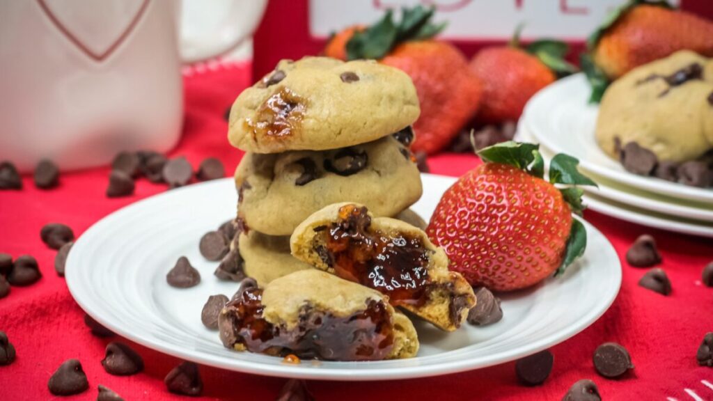 Chewy chocolate chip cookies are filled with gooey strawberry jam in this Chocolate Covered Strawberry Cookies recipe.