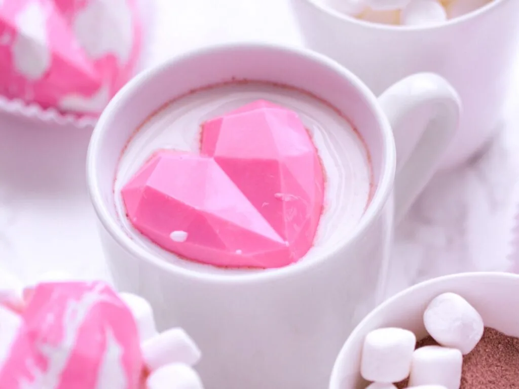 These geometric heart hot chocolate bombs are a fun and trendy Valentine’s Day treat for kids, featuring pink hot cocoa with Marshmallows.