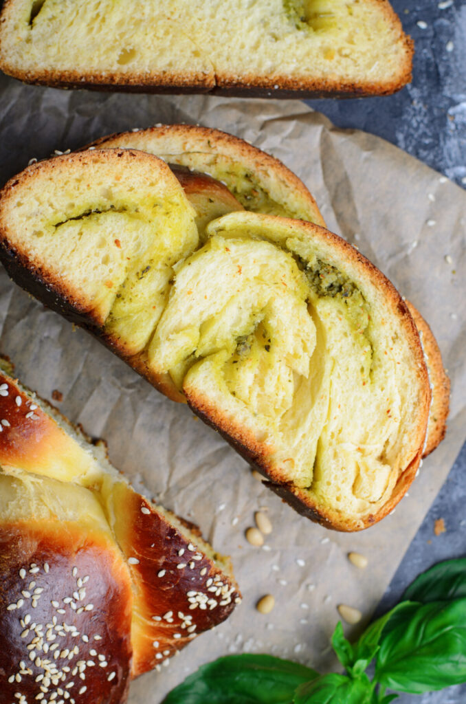 This Parmesan Pesto Challah Bread recipe makes a braided loaf that is light & fluffy with a golden crust, filled with swirls of pesto.