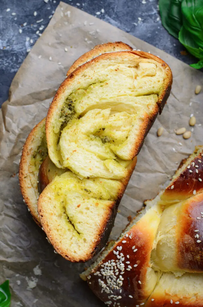 This Parmesan Pesto Challah Bread recipe makes a braided loaf that is light & fluffy with a golden crust, filled with swirls of pesto.