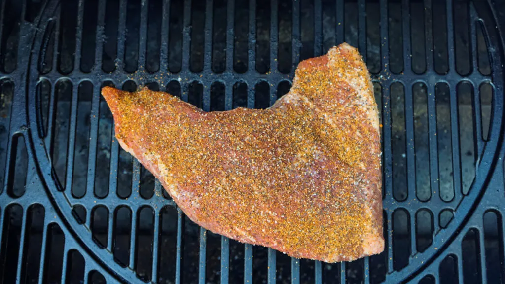 seasoned tri tip on the smoker grill.