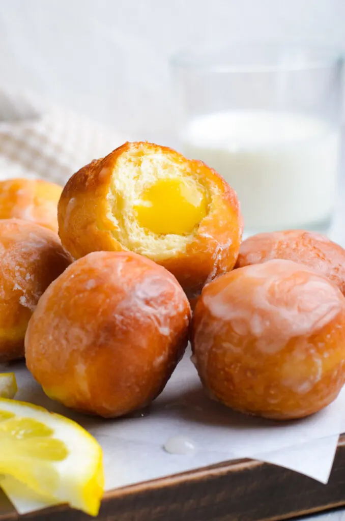 Lemon curd donut holes are a lemony delight - soft donut holes are filled with sweet and tart lemon curd, and covered with a sugar glaze.