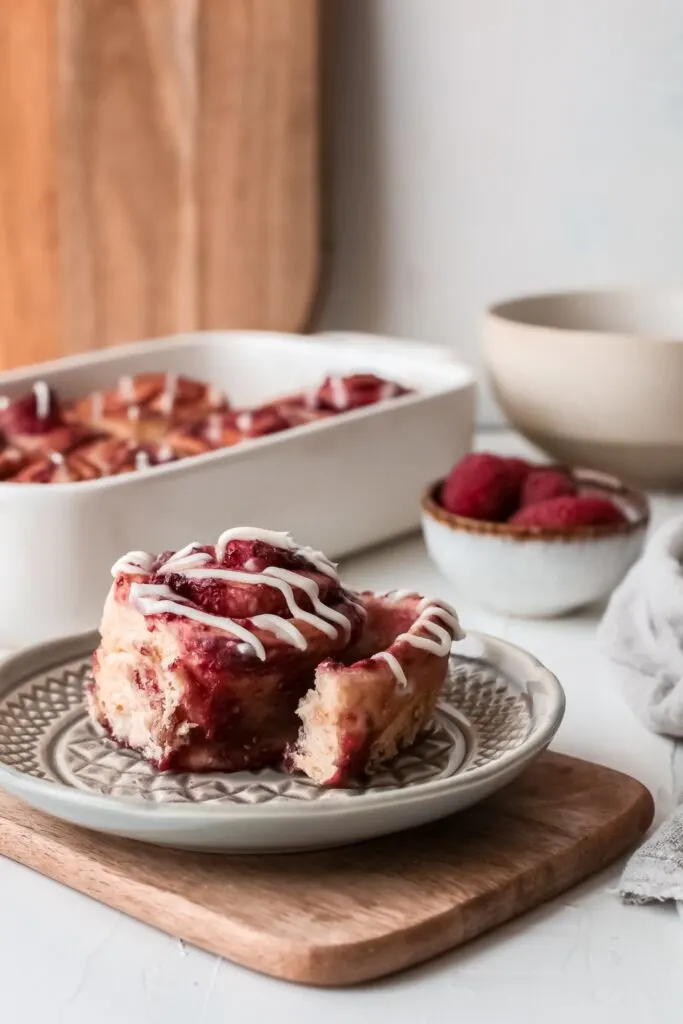 Raspberry Sweet Rolls - soft, fluffy and sweet yeast rolls filled with raspberries and smothered with cream cheese frosting.