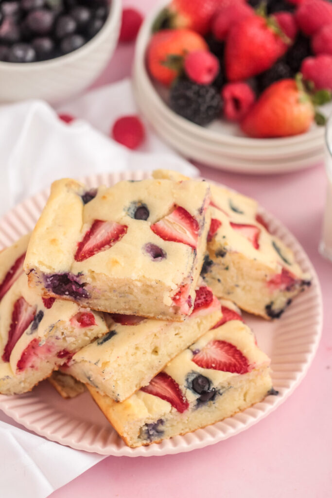 Feed a crowd at the breakfast table with these Berry Sheet Pan Pancakes! These are quick and easy fluffy pancakes bursting with fresh berries!