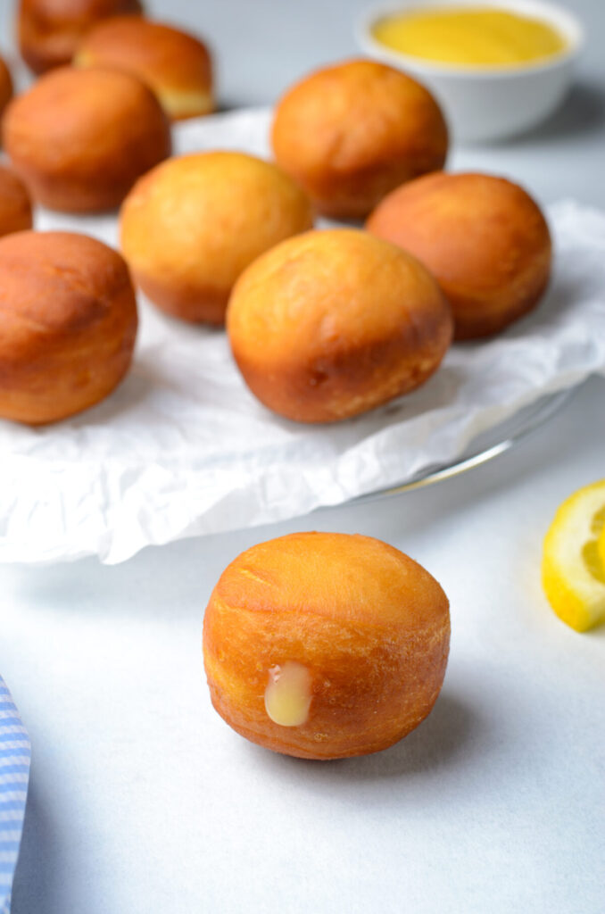 Lemon curd donut holes are a lemony delight - soft donut holes are filled with sweet and tart lemon curd, and covered with a sugar glaze.