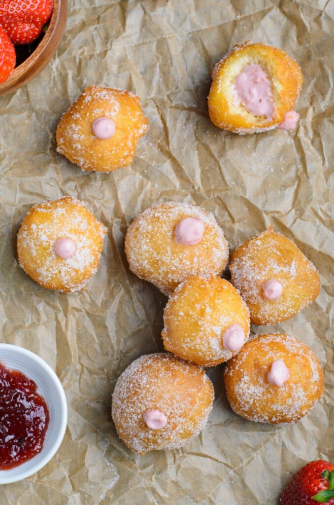 These Strawberry Cheesecake Donut Holes are fluffy fried cake donuts; rolled in sugar & stuffed with a creamy strawberry cheesecake filling. 