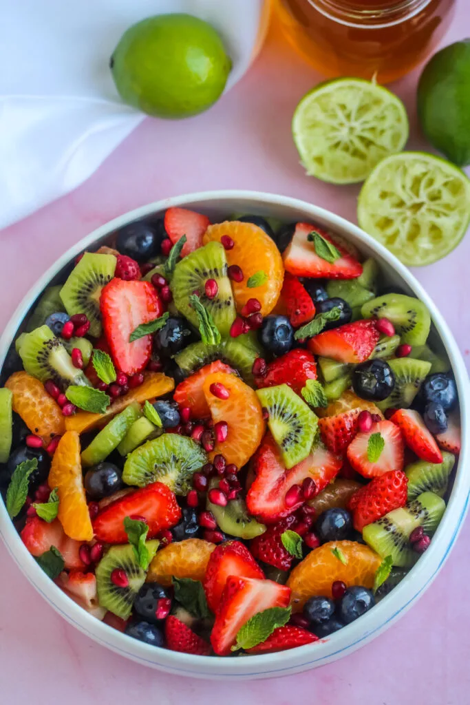 Honey Lime Fruit Salad is made with seasonal fruit and tossed in a fresh lime and honey dressing for a crowd-pleasing summer salad.