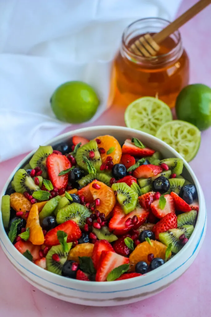 Honey Lime Fruit Salad is made with seasonal fruit and tossed in a fresh lime and honey dressing for a crowd-pleasing summer salad.