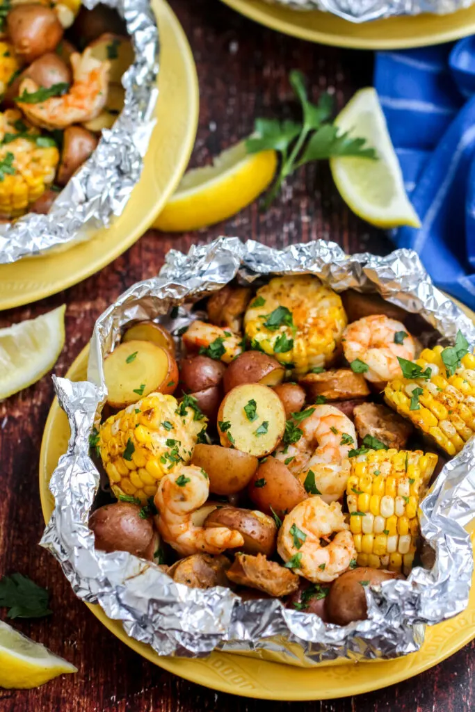 Cook these Shrimp Boil Foil Packets over a campfire, on the grill or in your oven for an easy family dinner with almost no cleanup!