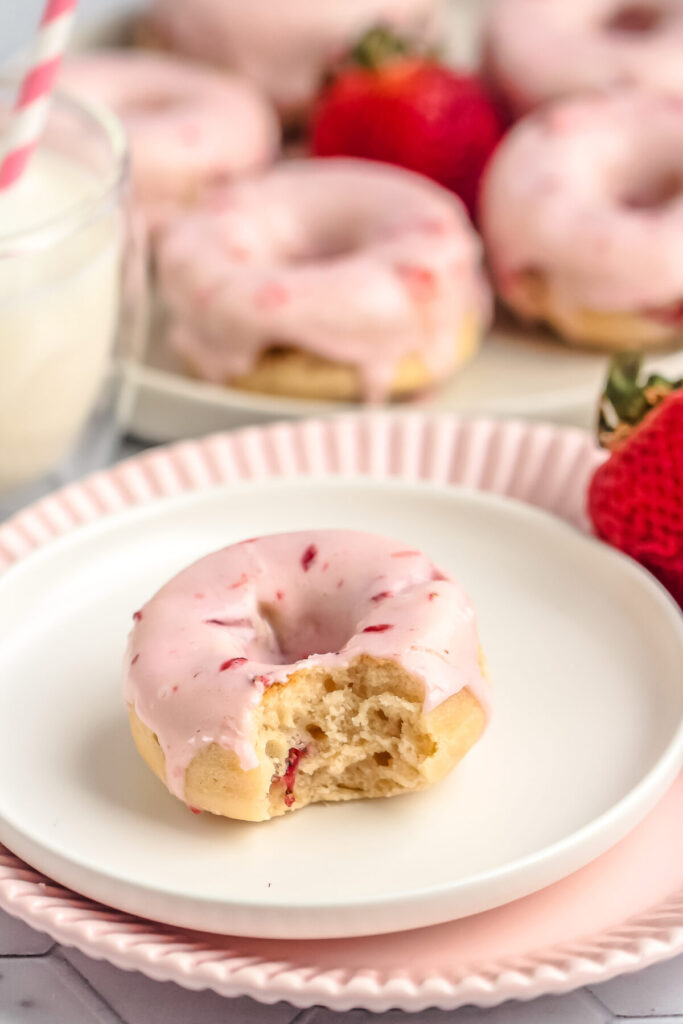 This Baked Strawberry Donuts recipe makes moist and fluffy donuts packed with fresh strawberries, topped off with a fresh strawberry glaze!